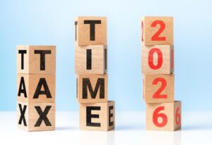 wooden blocks stacking spelling out tax time 2026