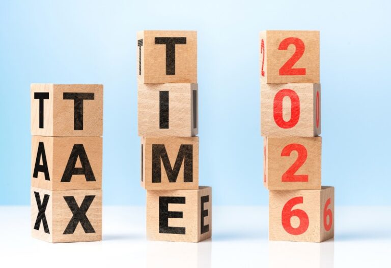 wooden blocks stacking spelling out tax time 2026