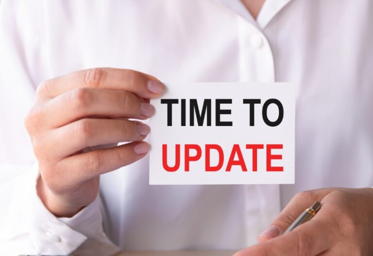 Close up of hand holding card that says time to update