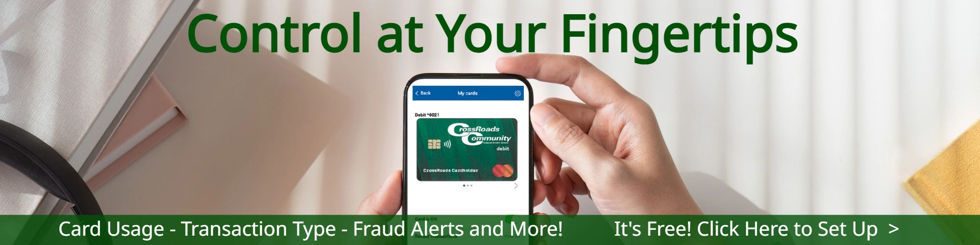 hand holding mobile phone using crossroad community fcu card hub app