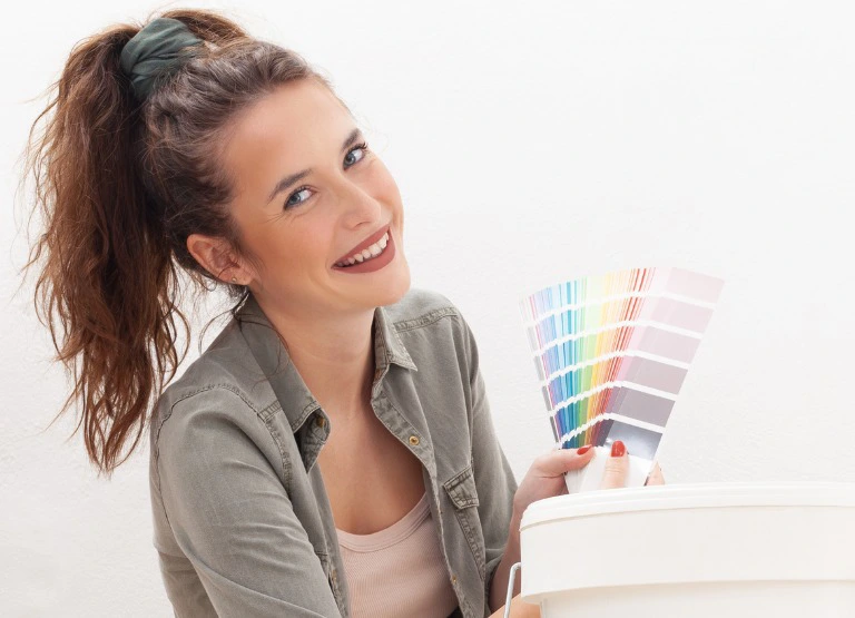 woman smiling and selecting color swatches