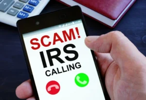 close up of hand holding a mobile phone getting an IRS scam call