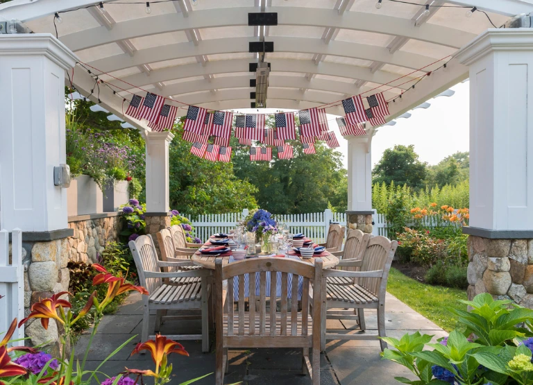 Home improvement outside patio space with table set and decorated for fourth of july.