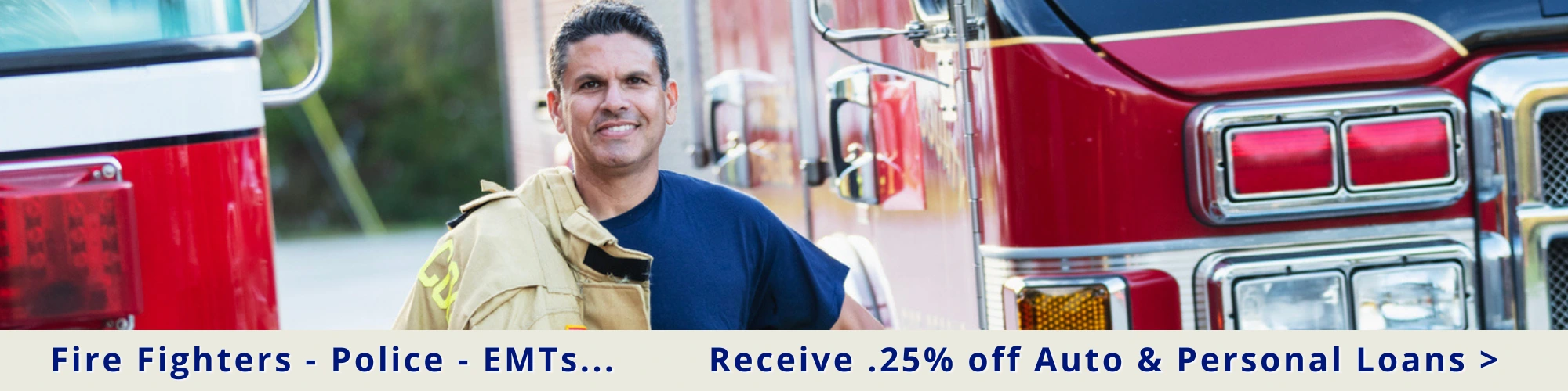 Fireman standing next to firetruck promoting crossroad community first responder .25% off auto and personal loans.