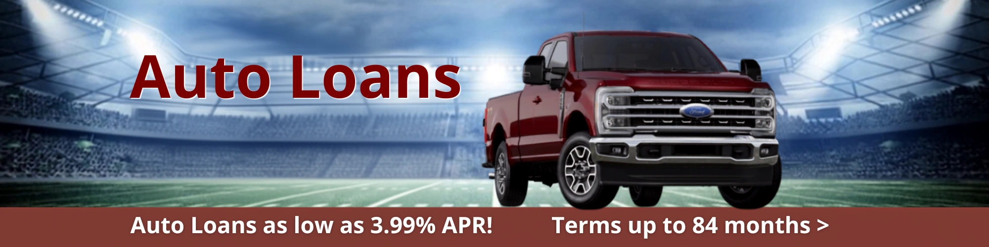 Red Truck on Football field. Auto Loans 3.99%apr at CrossRoad Community fcu