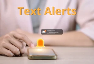 Close up of mobile phone on desk receiving a text notification