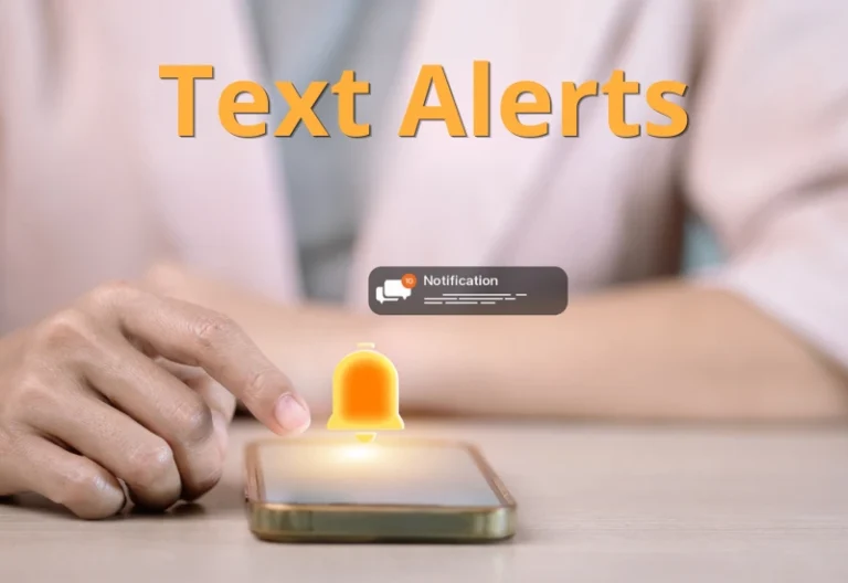 Close up of mobile phone on desk receiving a text notification